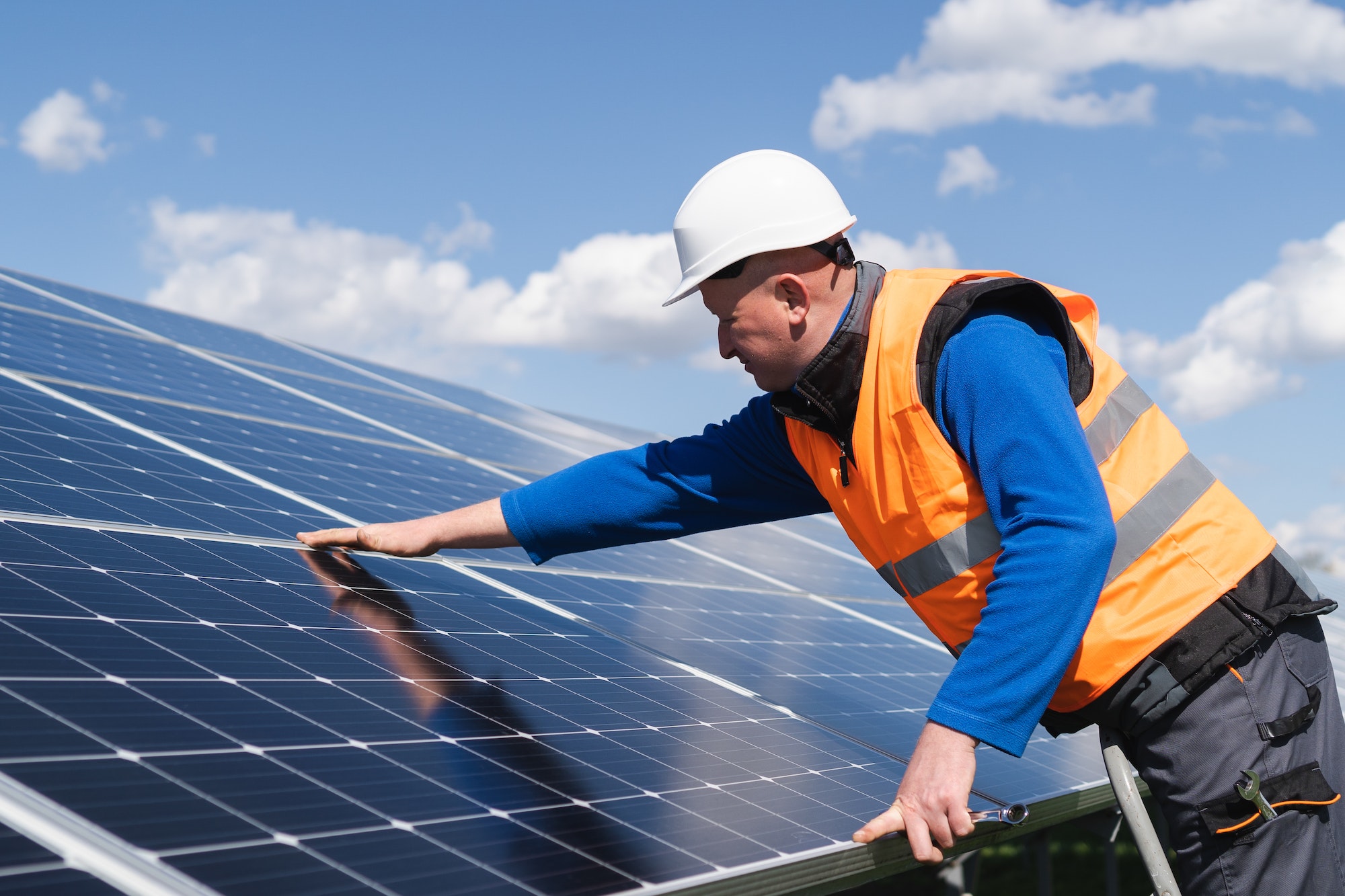 Solar power plant engineer makes a visual inspection of solar panels